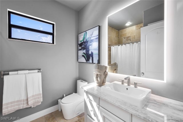 bathroom featuring vanity, curtained shower, and toilet