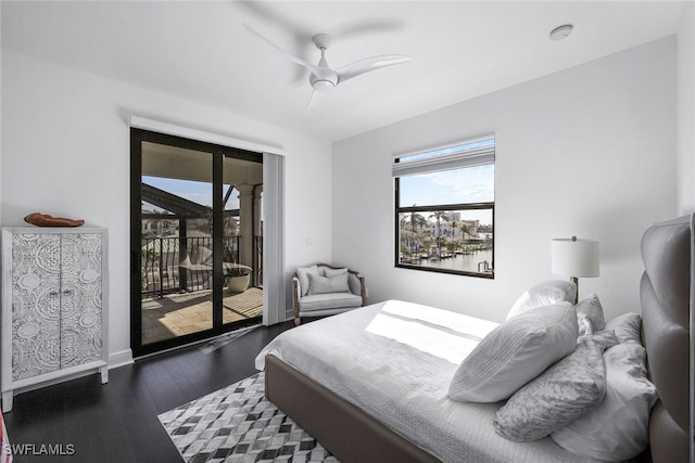 bedroom featuring access to exterior, dark hardwood / wood-style floors, and ceiling fan