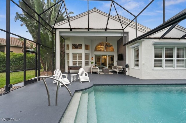 rear view of property with an outdoor hangout area, a patio area, ceiling fan, and glass enclosure