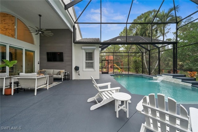 view of swimming pool with ceiling fan, an outdoor hangout area, a patio area, and glass enclosure