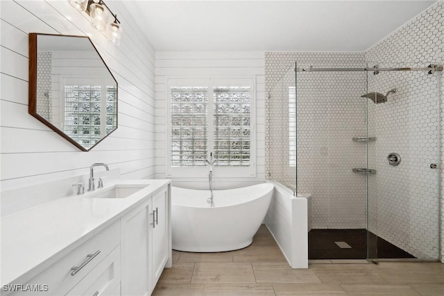 bathroom with vanity and separate shower and tub