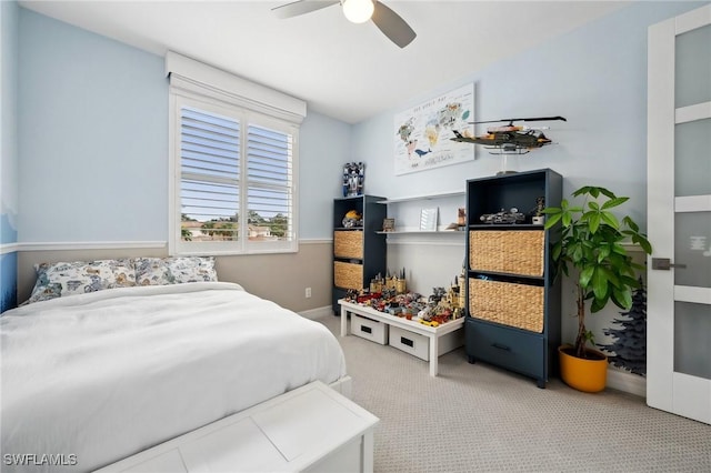 bedroom featuring ceiling fan and light carpet