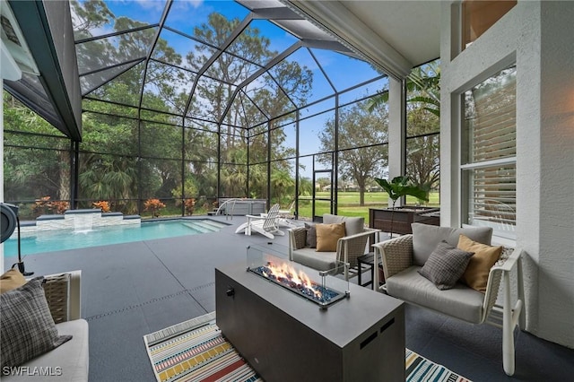 view of patio featuring a swimming pool with hot tub, a lanai, an outdoor living space with a fire pit, and pool water feature