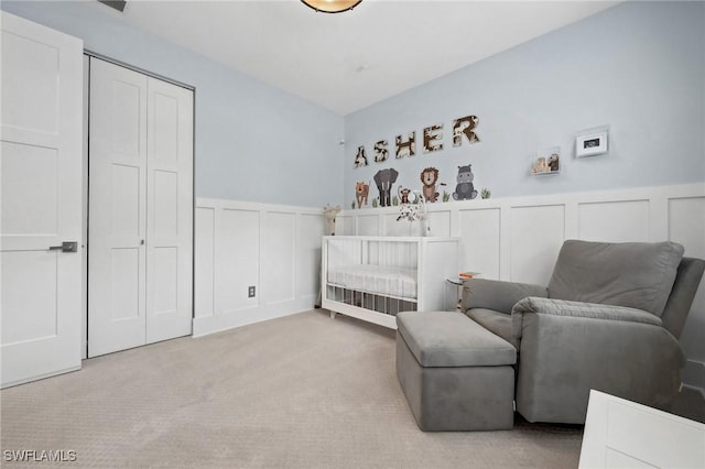 bedroom with a closet and light carpet