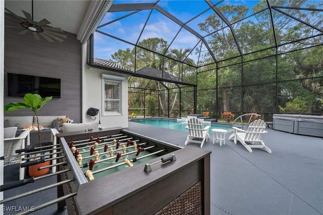 view of patio / terrace featuring a lanai, ceiling fan, and a pool with hot tub