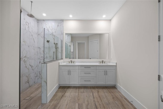 bathroom featuring vanity, tiled shower, and hardwood / wood-style floors