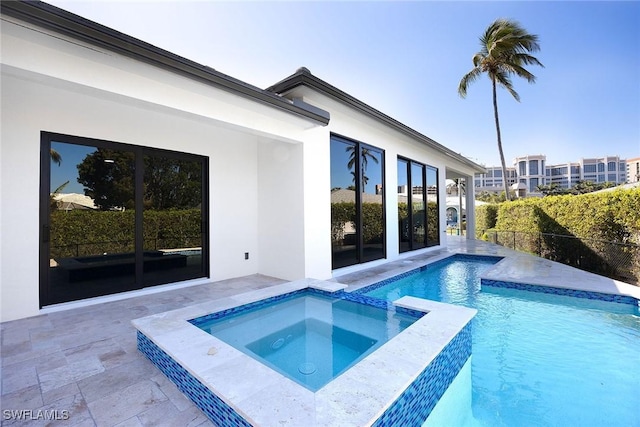 view of swimming pool with an in ground hot tub and a patio