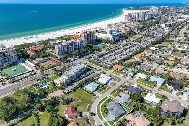 aerial view with a water view and a beach view