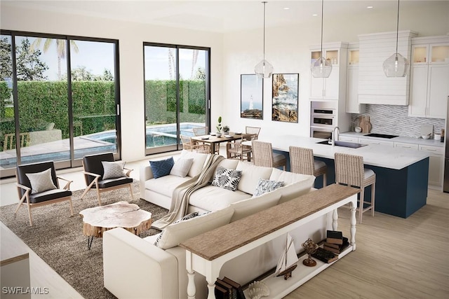 living room with sink and light wood-type flooring