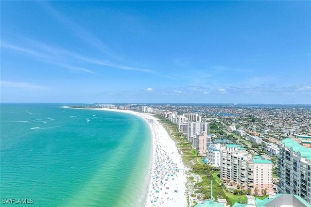 drone / aerial view featuring a water view and a beach view