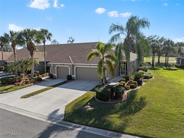 single story home featuring a garage and a front lawn