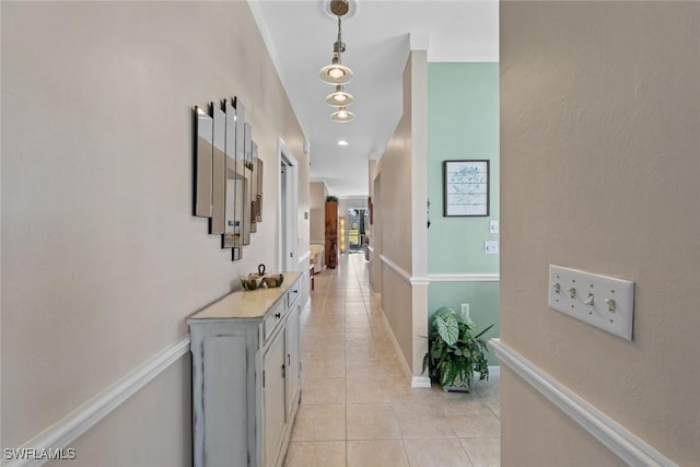 hallway featuring sink and light tile patterned floors