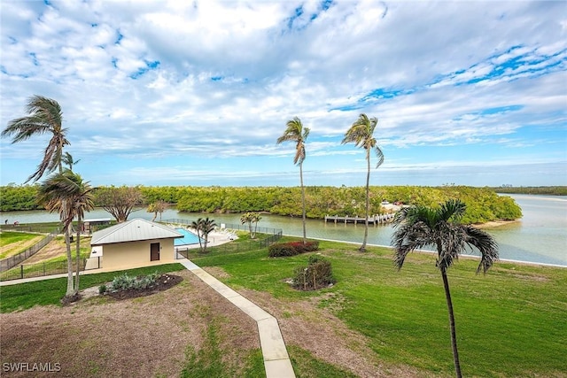 surrounding community with a lawn and a water view