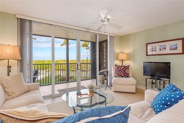 living area with a wall of windows, baseboards, and ceiling fan