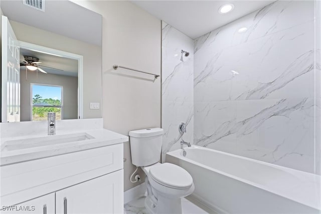 full bathroom featuring vanity, tiled shower / bath, toilet, and ceiling fan