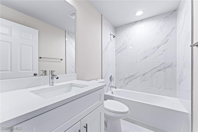 full bathroom with tile patterned flooring, tiled shower / bath, vanity, and toilet