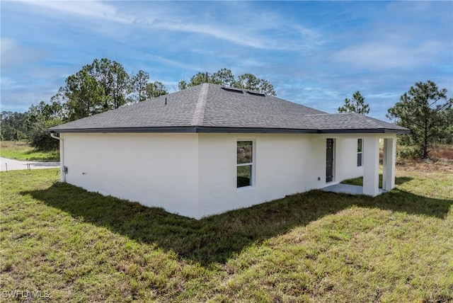 view of side of property with a lawn