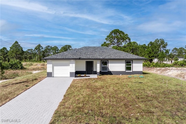 ranch-style house with a garage and a front lawn