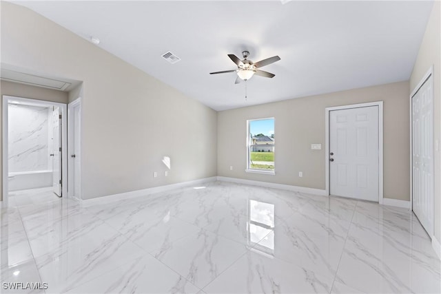 empty room with ceiling fan and vaulted ceiling