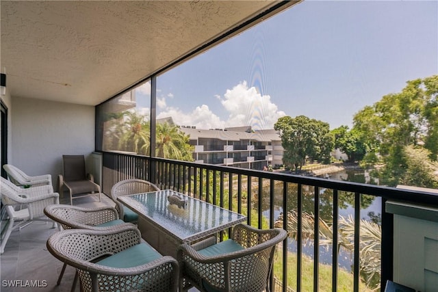 balcony featuring a water view