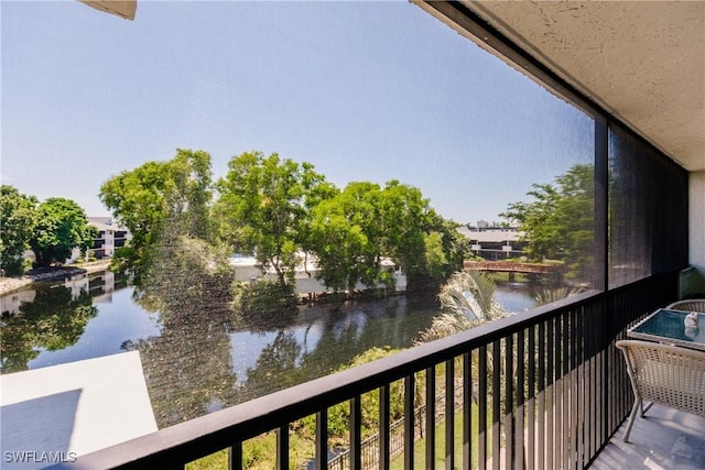 balcony featuring a water view