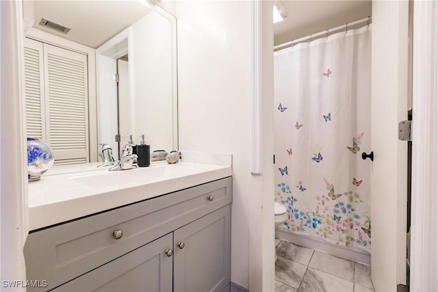 bathroom with vanity, toilet, and walk in shower