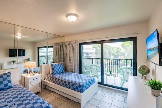 bedroom featuring light tile patterned flooring and access to exterior