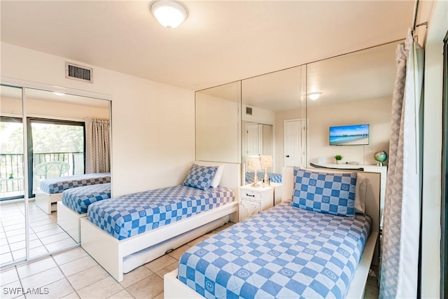 bedroom with access to exterior and light tile patterned flooring