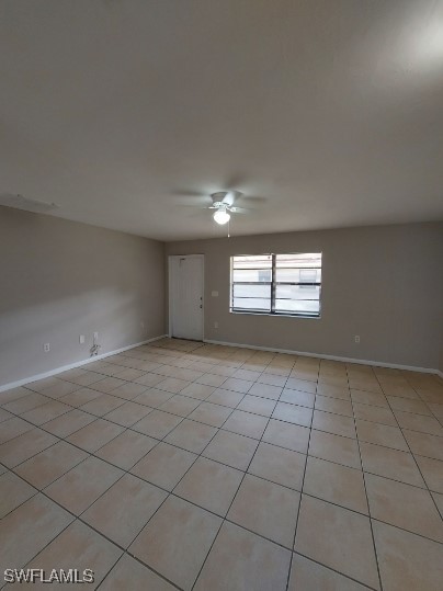 unfurnished room with ceiling fan and light tile patterned floors