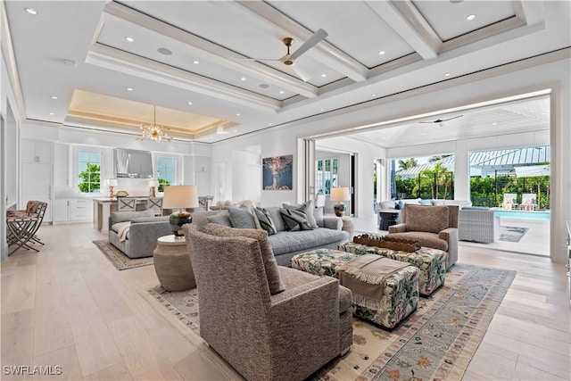 565 Anchor Rode Dr, Naples, FL 34103 - living room featuring ornamental molding, a tray ceiling, a chandelier, and light wood-style floors