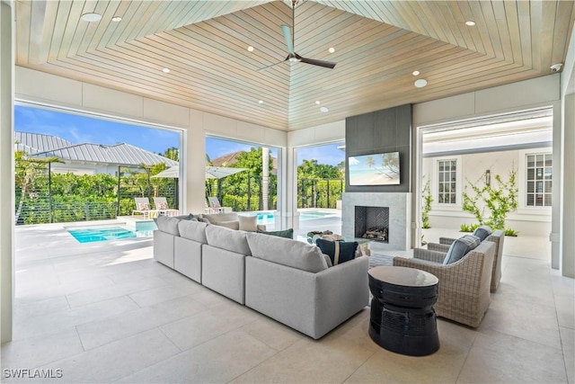 565 Anchor Rode Dr, Naples, FL 34103 - living room featuring light tile patterned floors, wooden ceiling, a ceiling fan, recessed lighting, and a large fireplace