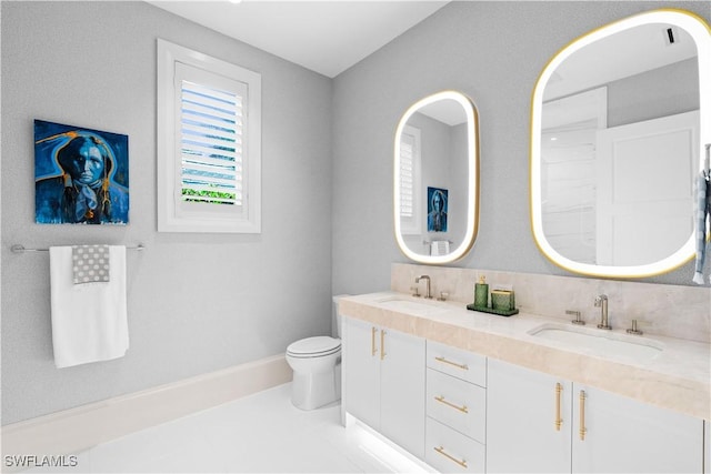 565 Anchor Rode Dr, Naples, FL 34103 - bathroom featuring a sink, toilet, and double vanity
