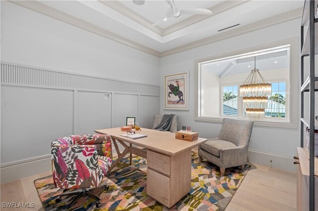 565 Anchor Rode Dr, Naples, FL 34103 - office space featuring an inviting chandelier, a decorative wall, a tray ceiling, wainscoting, and wood finished floors