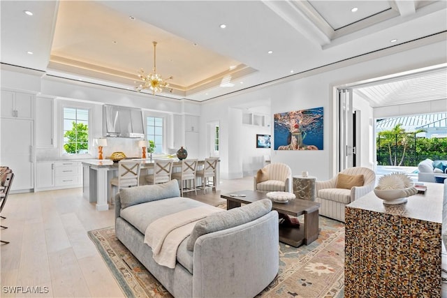 565 Anchor Rode Dr, Naples, FL 34103 - living room with a chandelier, recessed lighting, light wood-style flooring, and a tray ceiling
