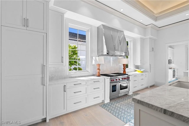 565 Anchor Rode Dr, Naples, FL 34103 - kitchen with ornamental molding, white cabinets, light wood finished floors, range hood, and double oven range