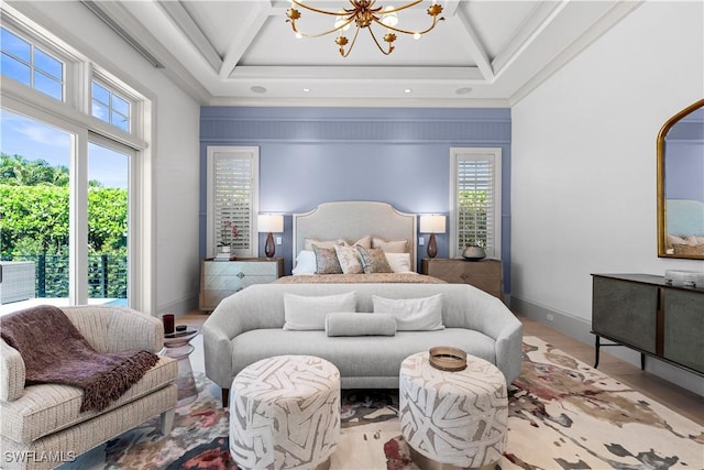 565 Anchor Rode Dr, Naples, FL 34103 - bedroom with a tray ceiling, a notable chandelier, multiple windows, and baseboards