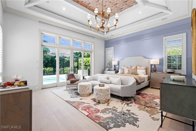 565 Anchor Rode Dr, Naples, FL 34103 - bedroom featuring a tray ceiling, light wood-style flooring, access to outside, and a chandelier