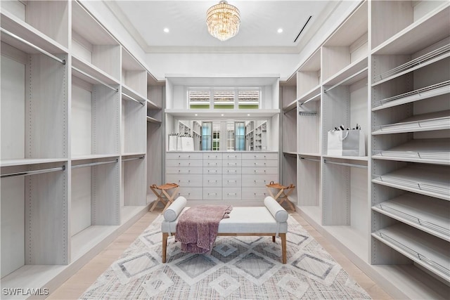 565 Anchor Rode Dr, Naples, FL 34103 - spacious closet featuring wood finished floors and an inviting chandelier