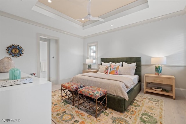 565 Anchor Rode Dr, Naples, FL 34103 - bedroom featuring ornamental molding, baseboards, a raised ceiling, and wood finished floors