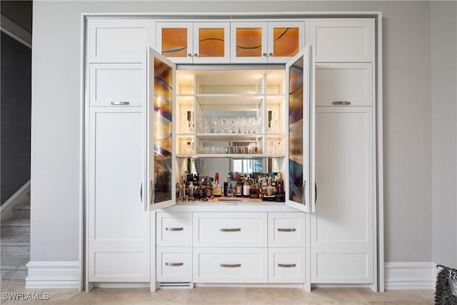 bar featuring white cabinets