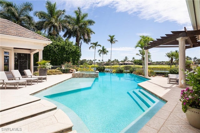 view of pool featuring a pool with connected hot tub, fence, a patio, and a pergola