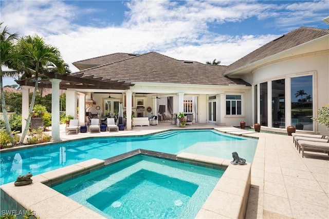 view of pool with a pergola, a pool with connected hot tub, a ceiling fan, an outdoor living space, and a patio