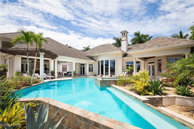 view of swimming pool with a patio area and french doors