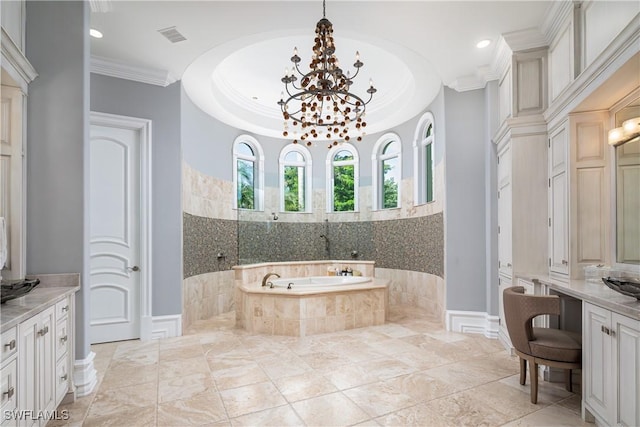 bathroom with ornamental molding, tiled bath, decorative columns, and vanity