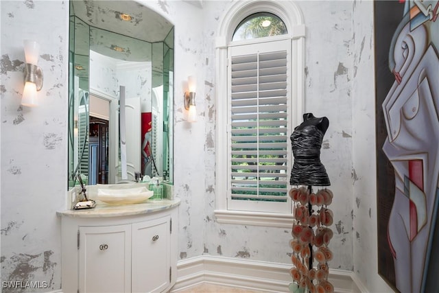 bathroom featuring vanity and wallpapered walls