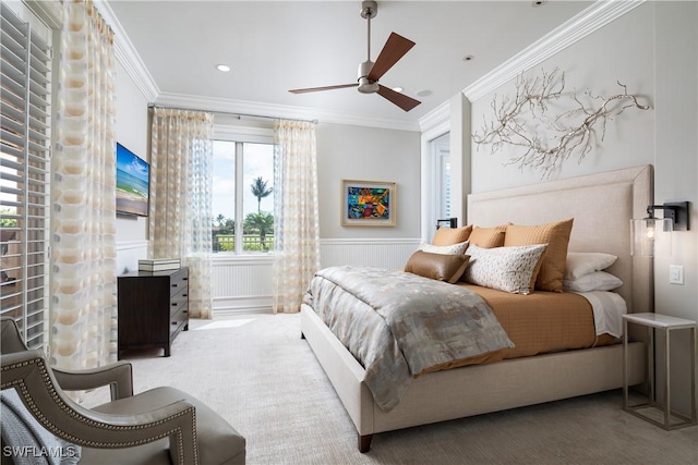bedroom with crown molding and wainscoting