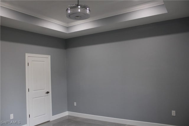 unfurnished room with a raised ceiling