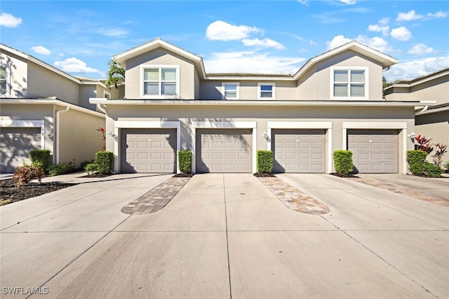 multi unit property featuring a garage