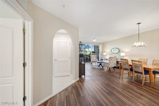 interior space featuring dark hardwood / wood-style floors and ceiling fan with notable chandelier