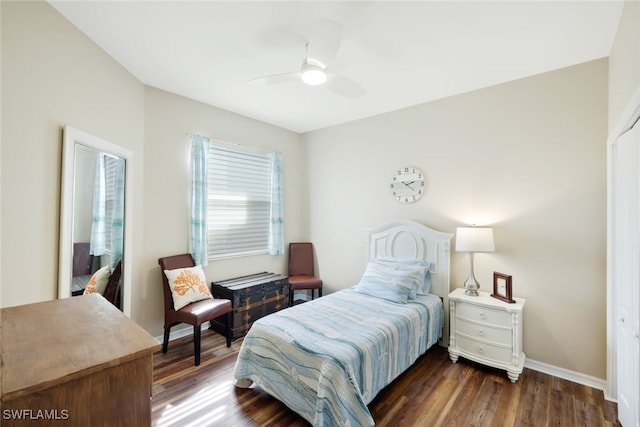 bedroom with dark hardwood / wood-style flooring and ceiling fan